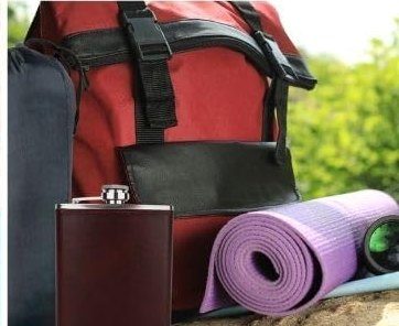 The flask beside a backpack at a campsite