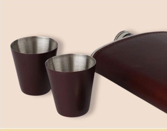Two dark brown pony shot cups with stainless interiors