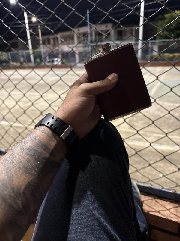 Customer photo: flask held in hand at night