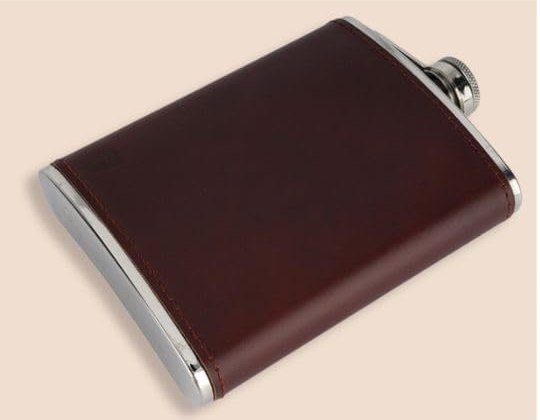 The brown leather flask lying flat