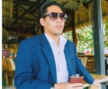 A groomsman holding the flask